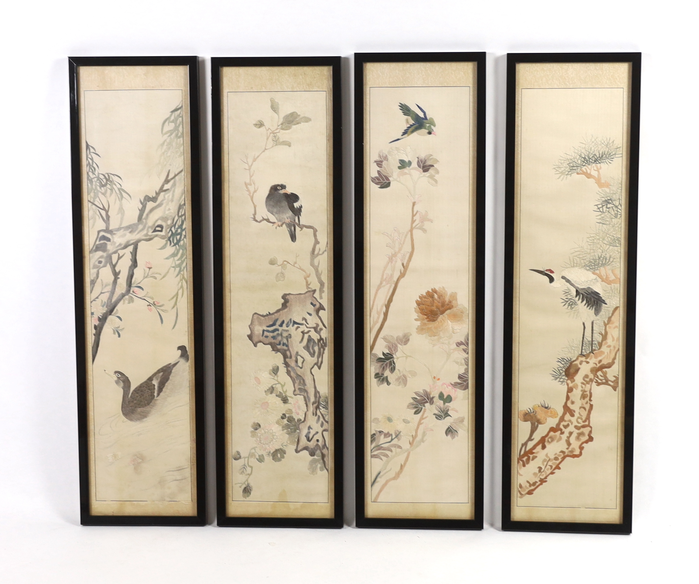 A set of four framed Chinese silk embroideries, of “The Four Seasons”, late Qing dynasty, embroidered with birds and trees and flowers, 96cm high x 22cm wide